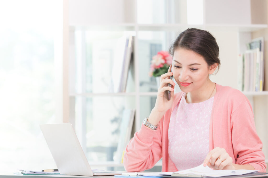 attractive businesswoman with inner confidence holding sitting working her small business from home