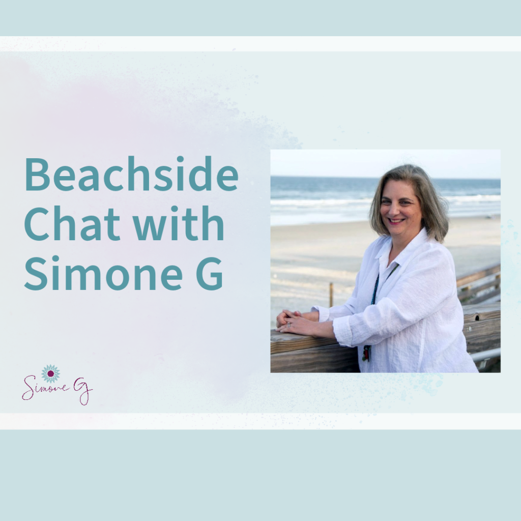 Simone G at beach wearing white top