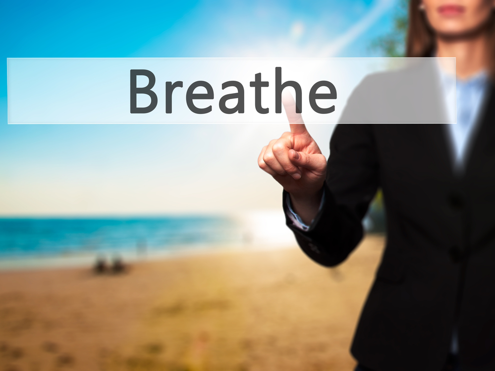 Breathe - Businesswoman pressing modern  buttons on a virtual screen. Concept of technology and  internet. A reminder to breathe in balance