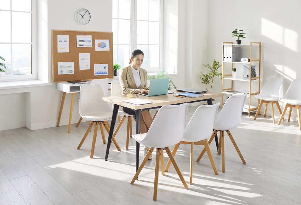woman at modern office table in peaceful environment working on laptop